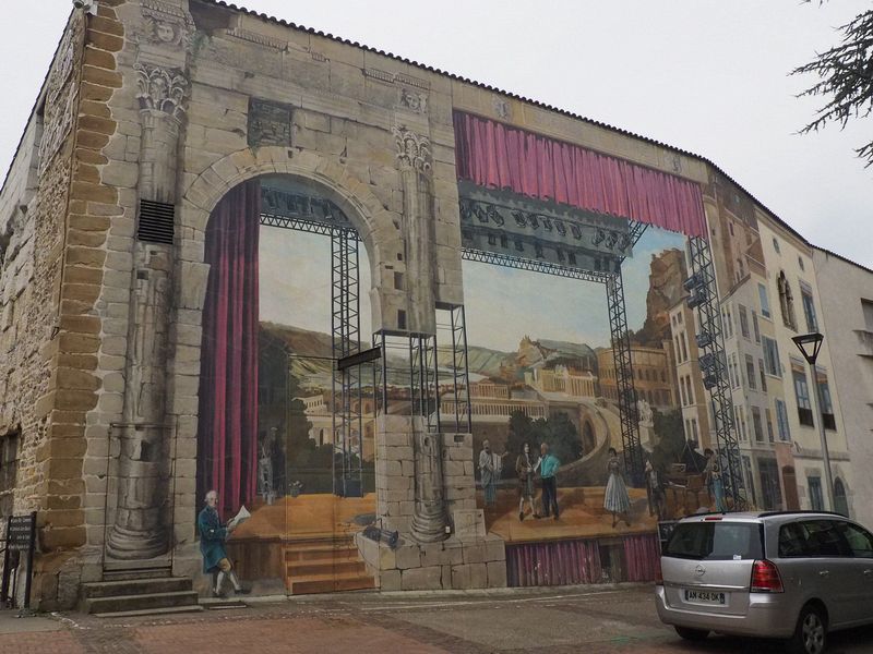 A huge mural on the side of a building showing Vienne's history